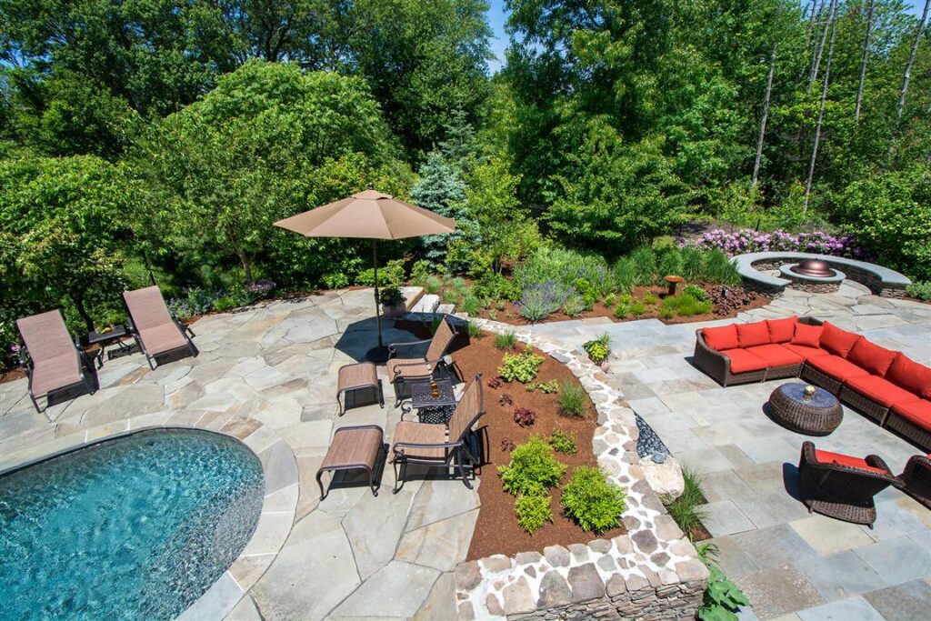 Landscape Design and Construction in Hingham, Massachusetts featuring multilevel patio with pool and water feature